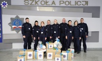 Zdjęcie grupowe przedstawicieli szkolnego samorządu na tle logo Szkoły Policji w Pile.