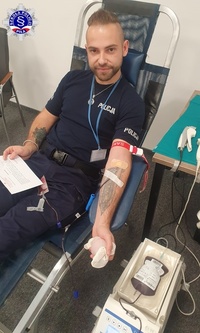 Umundurowany funkcjonariusz podczas oddawania krwi.