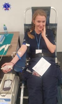 Umundurowany funkcjonariusz podczas oddawania krwi.